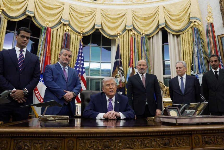 Trump signing documents regarding AI federal agency leadership at the White House desk, surrounded by five men in suits